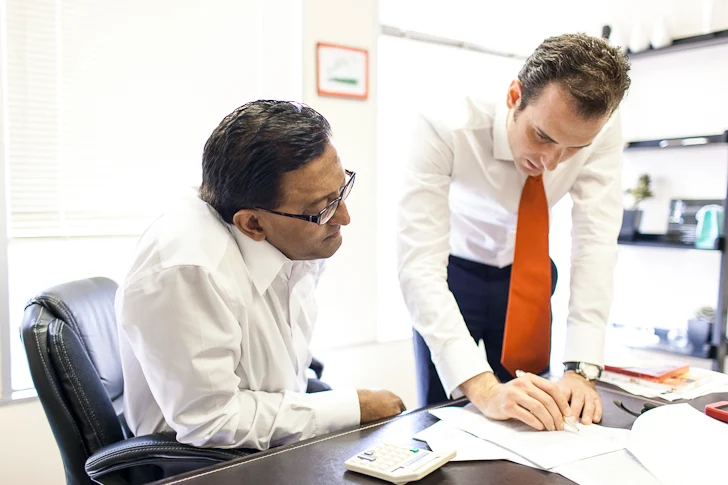 Arnold P. Peter and a Peter Law Group attorney discussing a California misclassification case